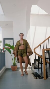 Woman wearing coordinated kimono robe with matching bralette and lounge shorts.