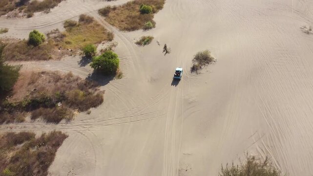 Aerial Top Down View of Off Road Vehicle Crossing Gumuk Pasir Parangkusumo Sand Dunes in Yogyakarta