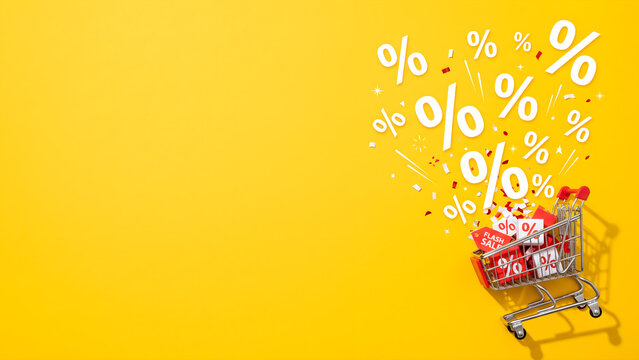 Shopping cart with discount symbols on a bright yellow background with copy space