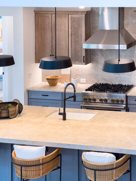Kitchen island with pendant lights and bar stools