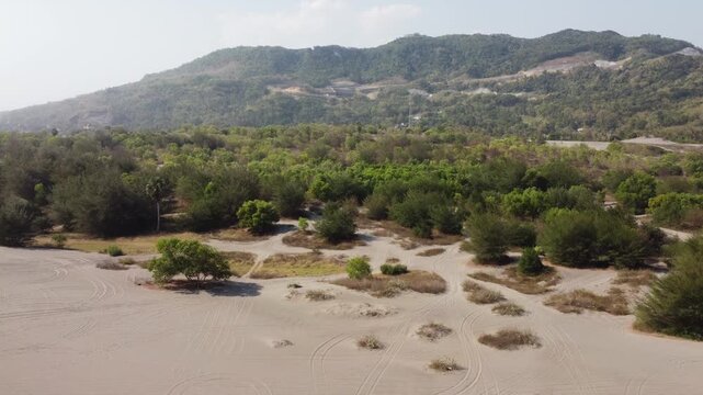 Aerial View of Gumuk Pasir Parangkusumo Sand Dunes with Coastal Forest and Hills in Yogyakarta, Indonesia