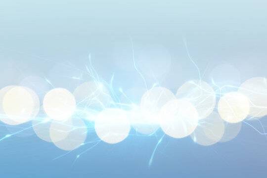 Abstract background of light blue shades with glare and bokeh effect.