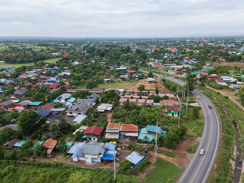 Aerial View of Rural Residential Area with Curving Road and Green Landscape