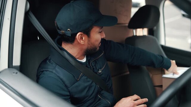 Logistics, writing and delivery man with clipboard in vehicle, smile and inventory for distribution. Supply chain, courier and happy person with checklist, notes and shipping update in transport