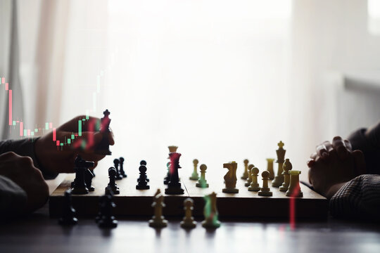 Black and White chess with player, Businessman and Businesswoman shaking hands after end game of thinking strategy to moving chess figure in competition with opposite player and planning.
