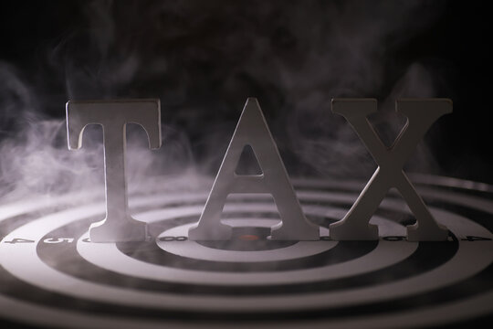 Dramatic Tax Concept with Smoke and Target Symbol Background