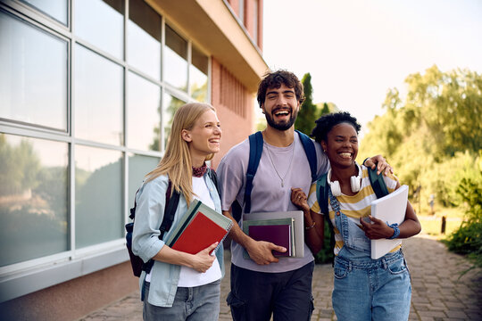 Cheerful college friends having fun at campus.