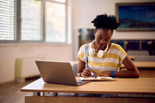 Black female student preparing for upcoming exams at university.