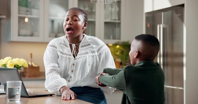 Remote work, mother and boy with laptop, frustration and childcare distraction in kitchen. WFH, stress and black family with interruption, freelance responsibility and parenting challenge in home.