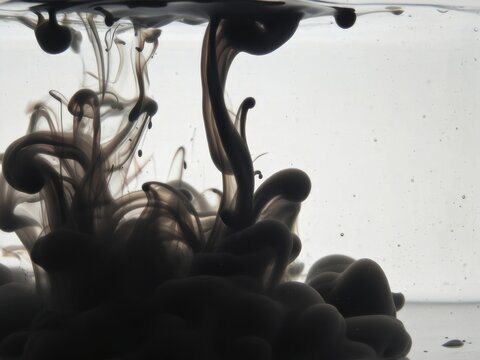 Black ink swirling abstract liquid in water