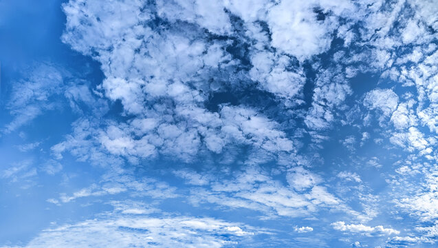 A small long clouds moves across the clear blue sky. The path of the rain is from left to right. White hat cloud dreaming in your imagination. Cirrus scenery texture detailed carpet.