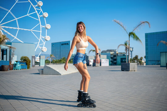 Young woman rollerblading in urban area enjoying summer day