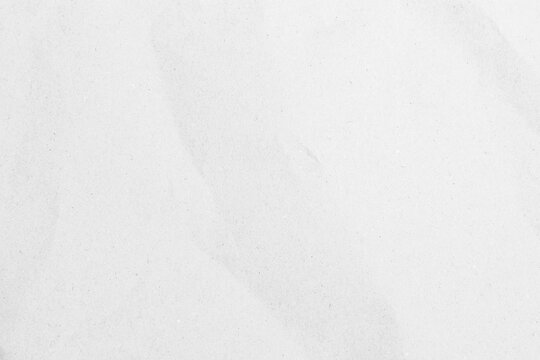 White recycled craft paper texture as background. Grey paper texture, Old vintage page or grunge vignette of old newspaper. Pattern rough art creased grunge letter. Hardboard with copy space for text.