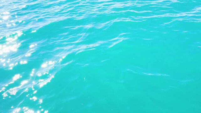 Turquoise ripple water reflection in tropical beach. Blue ocean waves. Summer sea. Waves in motion