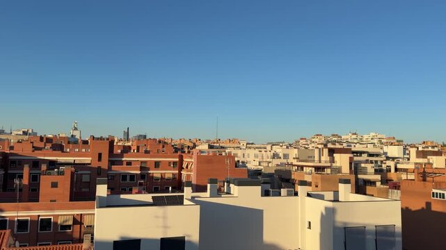 Golden hour shadows moving over madrid's rooftops