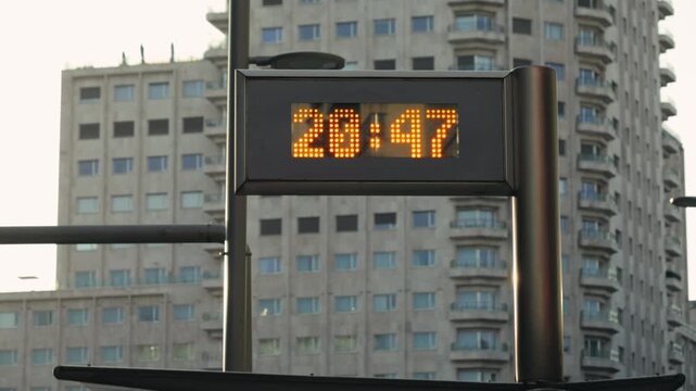 Digital outdoor thermometer displays 39 C on a city street, illustrating extreme summer heat, high temperatures, and urban heat wave conditions. High quality 4k footage