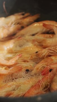 Vertical video. Tiger prawns fried in pan. Seafood. Shrimps cooking. Food prep.