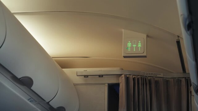 Airplane lavatory vacancy indicator showing restroom available inside passenger cabin. High quality 4k footage