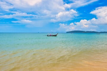 Obraz premium Thailand - Krabi - Ao Nang Beach July 22nd 2026. This was on a beautiful morning during the wet season. The Andaman sea during the low season surrounded by beautiful mountains. 