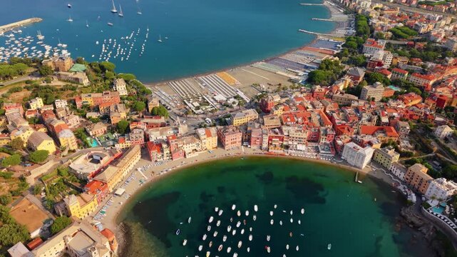 Aerial view of colorful seaside buildings and boats in a bay, coastal Liguria, Italy