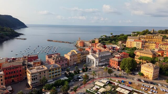 Sweeping drone view over colorful buildings and marina of Sestri Levante, Italy coast