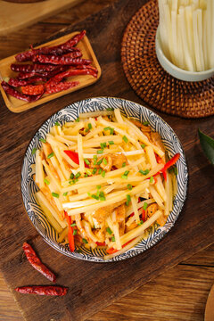 Fresh Bamboo Shoots Stir-Fry Chinese Cuisine Jiangxi Style with Red Peppers and Scallions on Rustic Wooden Table