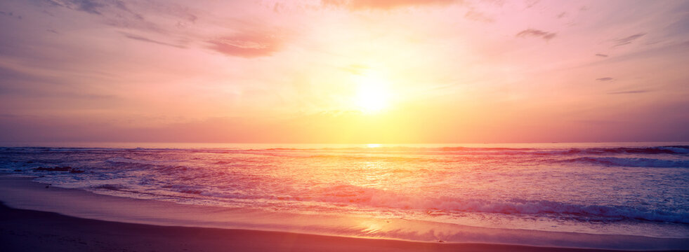 Seascape in the evening. Sunset over the sandy beach. Nature landscape