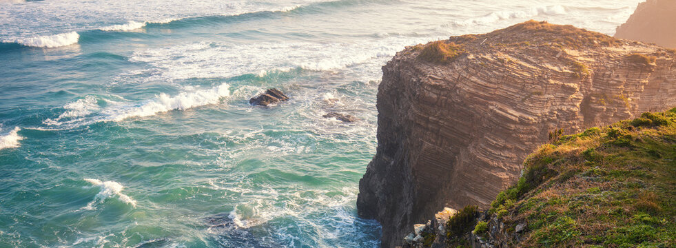Seascape on a sunny day. Beautiful quiet bay. Rocky sea coast at sunrise. Beach Praia de Augas Santas in Ribadeo. Galicia Spain Europe