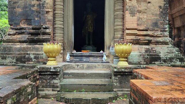 Upward Pan of Khmer Prasat Entrance with Incense Offerings at Preah Enkosei Temple Cambodia