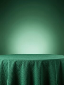 Empty Round Table Covered with Green Cloth Against a Dark Green Background with Spotlight.