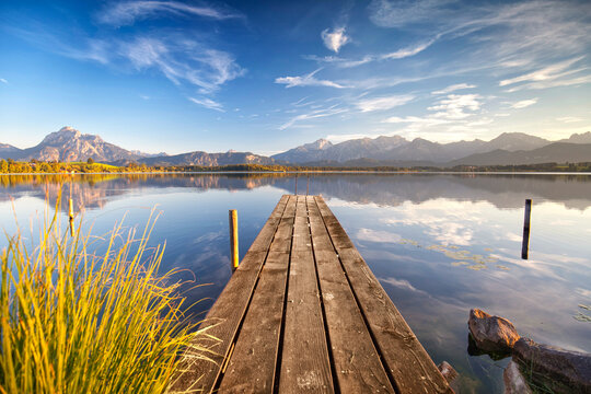 Crystal Clear Alpine Lake with a Wooden Pier on a Peaceful Summer Day