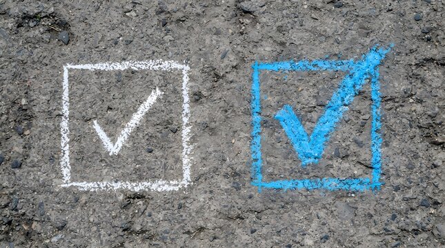 White and blue chalk check marks drawn in boxes on asphalt
