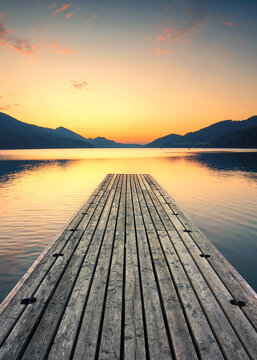 long wooden jetty on the lake, beautiful sunset