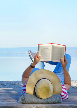 woman is reading a book, relax at the lake