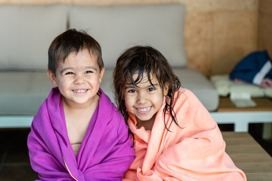 Two smiling white children wrapped