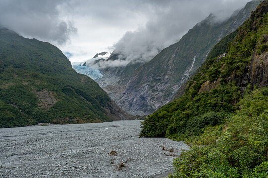 Franz Josef Glacier, Kā Roimata o Hine Hukatere, Gletscherzunge im Talkessel, Suedliche Alpen, Suedinsel, Neuseeland, Regenwald im Vordergrund, tief haengende Wolken