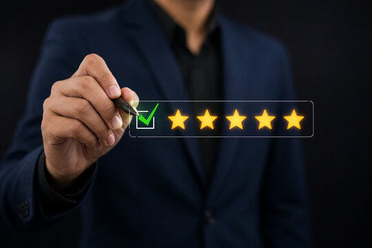 Businessman holding stylus marking five-star rating. Concept of customer satisfaction, feedback, online review, and quality service. 