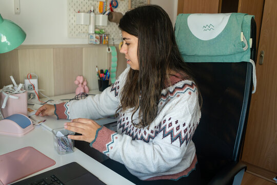 A white woman organizes stickers