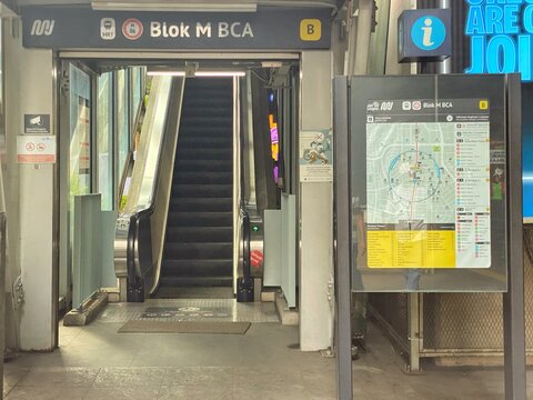 Jakarta, Indonesia - July 17, 2026: An entrance of Blok M BCA MRT Station featuring an escalator, station signage, and a public transport information board.