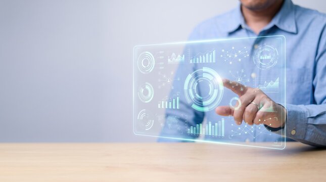 Man interacting with futuristic holographic data interface screen displaying charts graphs analytics statistics business information technology dashboard.