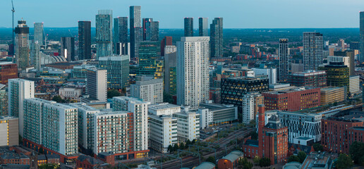 Naklejka premium Ultra Wide Aerial Panorama of Manchester City Centre Skyline, Affinity Living, and Deansgate Towers at Dusk
