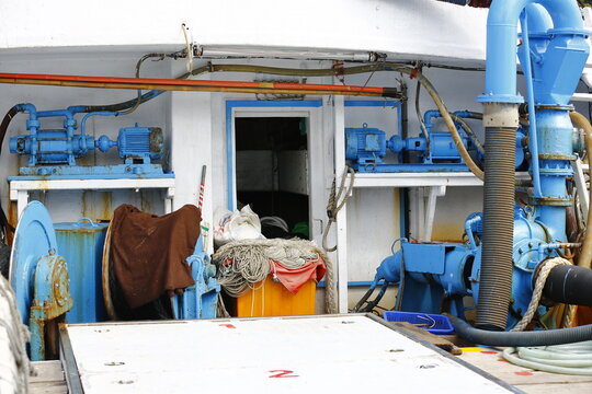Blue Pumping Equipment Fills a Fishing Boat Deck.