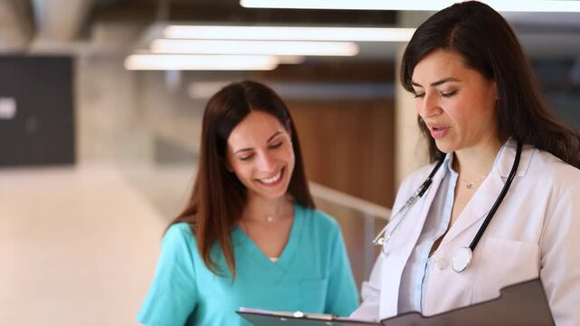Doctor and nurse collaborating in a hospital hallway