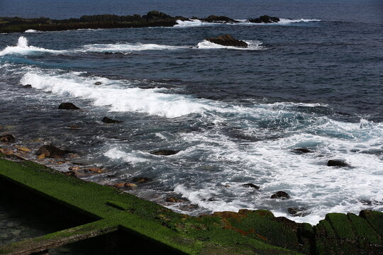 Ocean Waves Break Across a Rocky Shoreline.