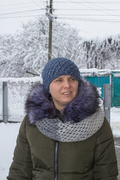 Woman in a warm winter jacket, Everyday life in a village or suburb in winter
