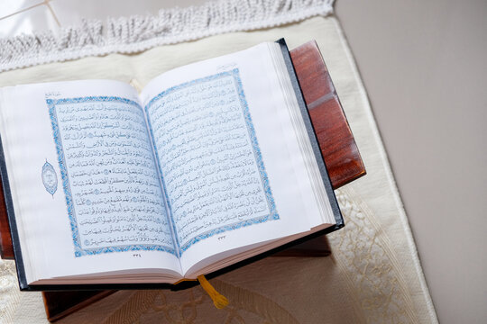 The holy Quran on a rehal, capturing a serene atmosphere of devotion