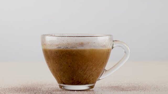 Instant Coffee Powder Pouring into Glass Cup of Hot Water