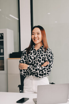 Confident asian business woman standing in modern office