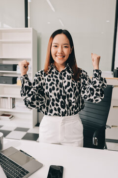 Confident asian business woman standing in modern office