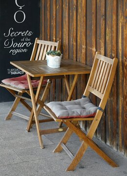 Outdoor cafe furniture with sign for Douro region